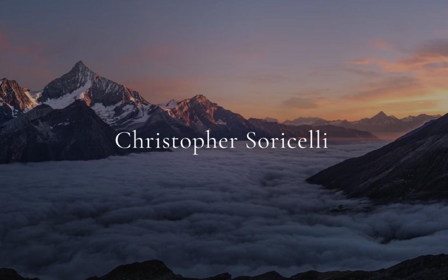 Christopher Soricelli author site: a mountain range above a sea of cloud at sunrise, with the author's name set across it.